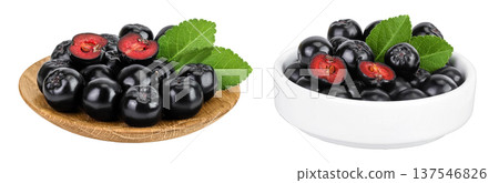 Chokeberry in wooden and ceramic bowl isolated on white background. Black aronia. Chokeberry in wooden and ceramic bowl isolated on white background. Black aronia. 137546826