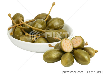 Capers in ceramic bowl isolated on white background. Pickled or canned capers. Capers in ceramic bowl isolated on white background. Pickled or canned capers. 137546899