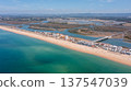 Praia de Faro along the coast in Ria Formosa, Algarve, Portugal, captured from above with clear water and land outlines on a sunny day 137547039