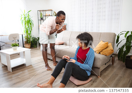 Mother scolding daughter using smartphone at home Mother scolding daughter using smartphone at home 137547335