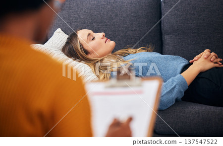 Therapy, sofa and woman relax in counselling for mental health, help for depression and listen to communication. Psychologist, consultation and patient lying on couch, writing notes and sleep comfort Therapy, sofa and woman relax in counselling for mental health, help for depression and listen to communication. Psychologist, consultation and patient lying on couch, writing notes and sleep comfort 137547522