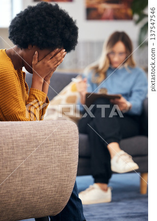 Mental health, stress and psychology with a black woman in therapy, talking to a professional. Anxiety, depression or support with a young patient in session with a psychologist for grief counseling Mental health, stress and psychology with a black woman in therapy, talking to a professional. Anxiety, depression or support with a young patient in session with a psychologist for grief counseling 137547546
