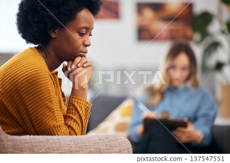 Mental health, depression and psychology with a black woman in therapy, talking to a professional. Anxiety, stress or support with a young patient in session with a psychologist for grief counseling Mental health, depression and psychology with a black woman in therapy, talking to a professional. Anxiety, stress or support with a young patient in session with a psychologist for grief counseling 137547551