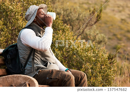 Black man, coffee or hiker hiking in a forest, nature or woods outdoors in adventure or bench to relax. Tea, fitness or thirsty African person trekking or walking on a journey refreshing on break Black man, coffee or hiker hiking in a forest, nature or woods outdoors in adventure or bench to relax. Tea, fitness or thirsty African person trekking or walking on a journey refreshing on break 137547682