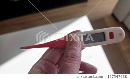 Digital thermometer in hand highlighting medical health concept Digital thermometer in hand highlighting medical health concept 137547688