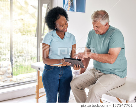 Senior man, physiotherapist and tablet for consultation, healthcare and rehabilitation. Chiropractor on technology for physical therapy of patient, happy black woman and recovery, healing or help Senior man, physiotherapist and tablet for consultation, healthcare and rehabilitation. Chiropractor on technology for physical therapy of patient, happy black woman and recovery, healing or help 137547701