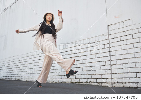 Road, walking kick and woman with travel, commute and streetwear fashion in New York. Vacation, city street and urban with a female person with traveling and vacation on a trip for holiday adventure Road, walking kick and woman with travel, commute and streetwear fashion in New York. Vacation, city street and urban with a female person with traveling and vacation on a trip for holiday adventure 137547703