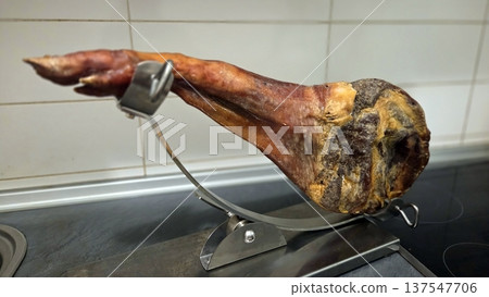 Cured spanish ham on display stand for gourmet dining and culinary presentation Cured spanish ham on display stand for gourmet dining and culinary presentation 137547706