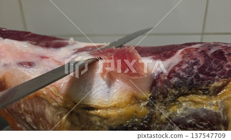 Traditional spanish ham slicing technique close-up for culinary inspiration Traditional spanish ham slicing technique close-up for culinary inspiration 137547709