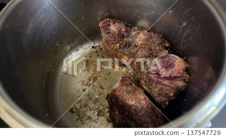 Slow cooked oxtail stew preparation for comfort food lovers. Traditional Spanish dish. Typical food of Spain Slow cooked oxtail stew preparation for comfort food lovers. Traditional Spanish dish. Typical food of Spain 137547729