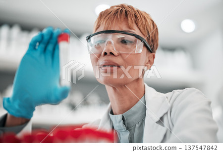 Woman, scientist and blood sample in lab, thinking and analysis with ppe glasses, safety and test. Science, pathology and expert with ideas, inspection or check for medical research in laboratory Woman, scientist and blood sample in lab, thinking and analysis with ppe glasses, safety and test. Science, pathology and expert with ideas, inspection or check for medical research in laboratory 137547842