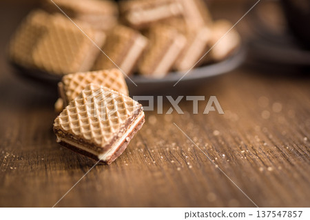 Crisp Chocolate Wafer Cookies Stacked On Wooden Table With Crumbs Close-Up Dessert Snack 137547857