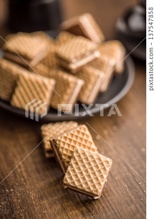 Crisp Chocolate Wafer Cookies Stacked On Wooden Table With Crumbs Close-Up Dessert Snack 137547858