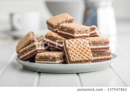 Stack of Chocolate Wafer Cookies on Plate With Layered Cream Filling, Crispy Dessert Snack Stack of Chocolate Wafer Cookies on Plate With Layered Cream Filling, Crispy Dessert Snack 137547862