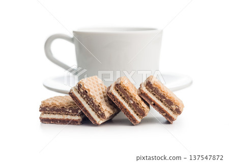 Stacked Chocolate Wafer Biscuits With Cream Layers and coffe cup On White Background .Sweet Dessert Snack 137547872