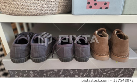 Children's footwear and storage baskets on shelf for organized home decor Children's footwear and storage baskets on shelf for organized home decor 137548072