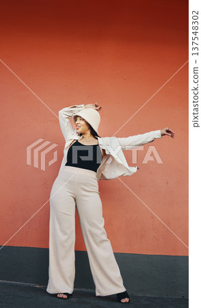 Happy woman, fashion and city wall with freedom, hipster style and urban clothes with confidence. Red background and stylish female person in town with cool and streetwear outfit and thinking Happy woman, fashion and city wall with freedom, hipster style and urban clothes with confidence. Red background and stylish female person in town with cool and streetwear outfit and thinking 137548302