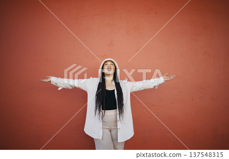 Excited woman, fashion and arms up for wall and mockup space with urban style and trendy clothing. Freedom, hipster female person and confidence with red background and edgy gen z clothes of a girl 137548315
