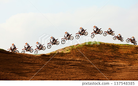 Motorcycle, sky and double exposure with a sports person on a ramp to jump during a race on an off road course. Bike, training and energy with an athlete on sand or dirt for speed, power or freedom Motorcycle, sky and double exposure with a sports person on a ramp to jump during a race on an off road course. Bike, training and energy with an athlete on sand or dirt for speed, power or freedom 137548385