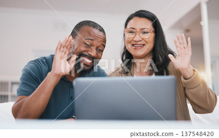 Laptop video call, communication and happy couple wave hello in virtual networking, contact or lounge chat. Computer, web communication and home man, woman or marriage people on online conference 137548420