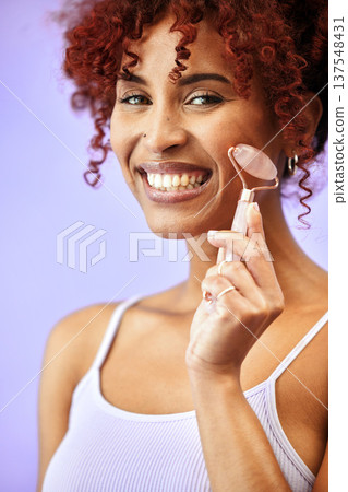 Portrait, rose quartz and woman in studio for skincare, anti aging or collagen circulation on purple background. Face, beauty and female model with roller facial, massage or wellness cosmetics Portrait, rose quartz and woman in studio for skincare, anti aging or collagen circulation on purple background. Face, beauty and female model with roller facial, massage or wellness cosmetics 137548431