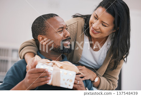 Birthday, smile and couple with present box, anniversary package or product for love, congratulations or gratitude. Home, lounge and happy woman, black man or marriage people with thank you gift Birthday, smile and couple with present box, anniversary package or product for love, congratulations or gratitude. Home, lounge and happy woman, black man or marriage people with thank you gift 137548439