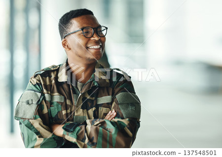 Soldier with smile, confidence and arms crossed at army building, pride and happy professional in sevice. Military career, security and courage, black man in camouflage uniform at government agency. 137548501