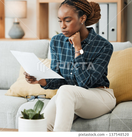 Planning, budget or black woman reading paperwork, bank document and investment report in home. Savings, insurance documents or African lady with loan information for financial future in living room Planning, budget or black woman reading paperwork, bank document and investment report in home. Savings, insurance documents or African lady with loan information for financial future in living room 137548520