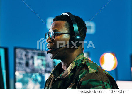 Military, call center and man on computer in office, data center and monitor for technical support, cybersecurity or surveillance. Army, officer and work in tech, security or government communication Military, call center and man on computer in office, data center and monitor for technical support, cybersecurity or surveillance. Army, officer and work in tech, security or government communication 137548553