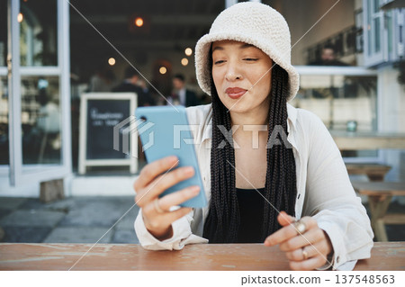 Student, travel and woman with phone at a cafe for social media, texting or chatting in a city. Smartphone, app and lady influencer at coffee shop for content creation, podcast or traveling blog post Student, travel and woman with phone at a cafe for social media, texting or chatting in a city. Smartphone, app and lady influencer at coffee shop for content creation, podcast or traveling blog post 137548563