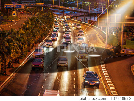Ufo, spaceship light and traffic in city at night for alien mission, science fiction and fantasy in sky with surreal glow. Spacecraft, mystery and flying saucer from outer space for discovery Ufo, spaceship light and traffic in city at night for alien mission, science fiction and fantasy in sky with surreal glow. Spacecraft, mystery and flying saucer from outer space for discovery 137548630