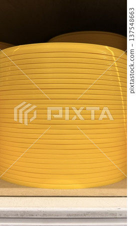 Yellow ribbed plastic surface. Abstract industrial background with horizontal lines. Yellow ribbed plastic surface. Abstract industrial background with horizontal lines. 137548663
