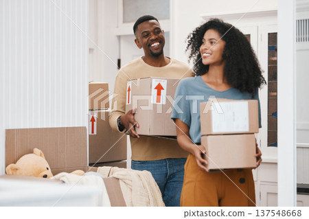 Happy black couple, box and moving in new home, property or investment together in happiness. African man and woman smile with boxes in renovation, relocation or house mortgage and apartment loan Happy black couple, box and moving in new home, property or investment together in happiness. African man and woman smile with boxes in renovation, relocation or house mortgage and apartment loan 137548668