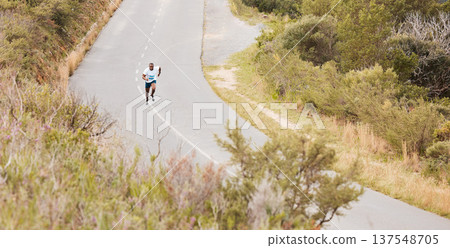 Fitness, hill or runner running on a road by nature for exercise, training or outdoor workout. Sports race, fast black man or healthy active athlete on street with endurance, freedom or challenge Fitness, hill or runner running on a road by nature for exercise, training or outdoor workout. Sports race, fast black man or healthy active athlete on street with endurance, freedom or challenge 137548705