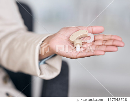 Hearing aid, medical and deaf with hands of person with a disability for healthcare, technology and sound waves. Medicine, wellness and audio with closeup of cochlear implant for hearing treatment Hearing aid, medical and deaf with hands of person with a disability for healthcare, technology and sound waves. Medicine, wellness and audio with closeup of cochlear implant for hearing treatment 137548728