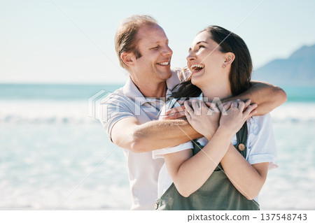 Happy, couple and hug by the sea with love, laughing and bonding on vacation at ocean. Summer, romance and people together for holiday by the beach in Bali with adventure and journey on honeymoon Happy, couple and hug by the sea with love, laughing and bonding on vacation at ocean. Summer, romance and people together for holiday by the beach in Bali with adventure and journey on honeymoon 137548743
