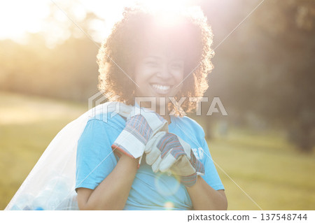 Nature portrait, community volunteer and happy woman cleaning garbage, eco waste and plastic trash. Sunshine, NGO service and activist support park clean up, outreach project or environment pollution 137548744