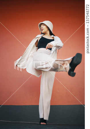 Woman kick, fashion and city wall with freedom, hipster style and urban clothes with confidence. Red background, traveling and stylish female person in town with cool and modern outfit and thinking Woman kick, fashion and city wall with freedom, hipster style and urban clothes with confidence. Red background, traveling and stylish female person in town with cool and modern outfit and thinking 137548772