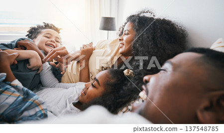 Family, laughing and living room with kids, father and love together in a home in bed. Mother, relax and children with dad and funny joke with bonding, support and care in house with happy people 137548785