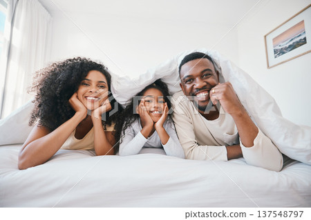 Family, portrait and relax in bedroom, happiness and love with bonding at home, parents with girl kid in the morning. Smile, support and care with people in bed, blanket and comfort with relationship Family, portrait and relax in bedroom, happiness and love with bonding at home, parents with girl kid in the morning. Smile, support and care with people in bed, blanket and comfort with relationship 137548797