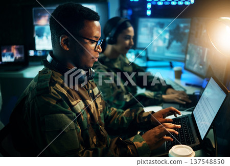 Military control room, computer and soldier at desk, typing code and tech for communication army office. Security, global surveillance and black man at laptop in government cyber data command center. Military control room, computer and soldier at desk, typing code and tech for communication army office. Security, global surveillance and black man at laptop in government cyber data command center. 137548850