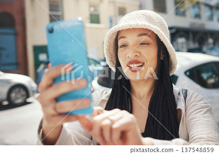 Happy woman on city street with phone, travel blog and live streaming for social media post on holiday. Influencer, streamer or gen z girl with urban fashion, smartphone and smile for content creator Happy woman on city street with phone, travel blog and live streaming for social media post on holiday. Influencer, streamer or gen z girl with urban fashion, smartphone and smile for content creator 137548859
