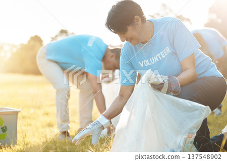 Nature recycling, community service volunteer and happy woman cleaning garbage, trash or pollution. Earth Day teamwork, eco friendly environment and charity team help with sustainable park clean up Nature recycling, community service volunteer and happy woman cleaning garbage, trash or pollution. Earth Day teamwork, eco friendly environment and charity team help with sustainable park clean up 137548902