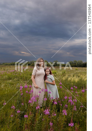 Mother And Daughter Share Comforting Moment Amidst Wildflowers During Threatening Storm Clouds Mother And Daughter Share Comforting Moment Amidst Wildflowers During Threatening Storm Clouds 137548964