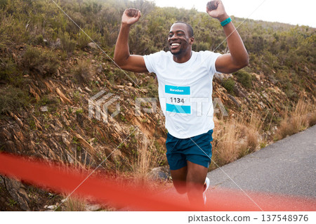 Black man, winner of race and fitness with cheers, athlete and sports with running in street and competition. Marathon, winning and celebration with African runner, happy champion and success outdoor Black man, winner of race and fitness with cheers, athlete and sports with running in street and competition. Marathon, winning and celebration with African runner, happy champion and success outdoor 137548976