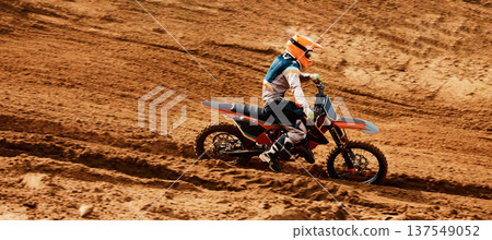 Motorcycle, freedom and speed with a sports man on space in the desert for dirt biking. Bike, fitness and power with a person driving fast on an off road course for a performance challenge on sand Motorcycle, freedom and speed with a sports man on space in the desert for dirt biking. Bike, fitness and power with a person driving fast on an off road course for a performance challenge on sand 137549052