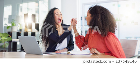 Laptop, success and business women high five to celebrate goals, targets or achievement in office. Winner, wow surprise and happy friends or employees in celebration of winning, promotion and bonus. 137549140