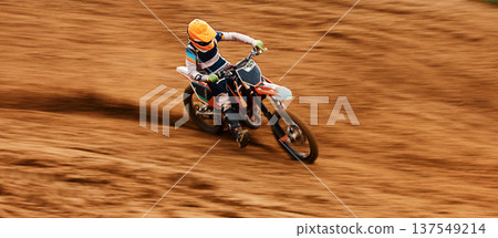 Bike, dust and motion blur with a sports man on space in the desert for dirt biking. Motorcycle, exercise and power with a person driving fast on sand or off road course for freedom or performance 137549214