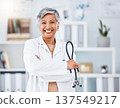 Doctor, senior woman and stethoscope, arms crossed for healthcare in hospital and professional cardiovascular surgeon. Portrait, health and medical tools with confidence, medicine and cardiology 137549217