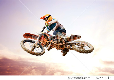 Sky background, motorcycle and jump for training or sports with fitness, balance or challenge in nature on mock up space. Bike, freedom and adventure for competition and exercise with safety gear Sky background, motorcycle and jump for training or sports with fitness, balance or challenge in nature on mock up space. Bike, freedom and adventure for competition and exercise with safety gear 137549218